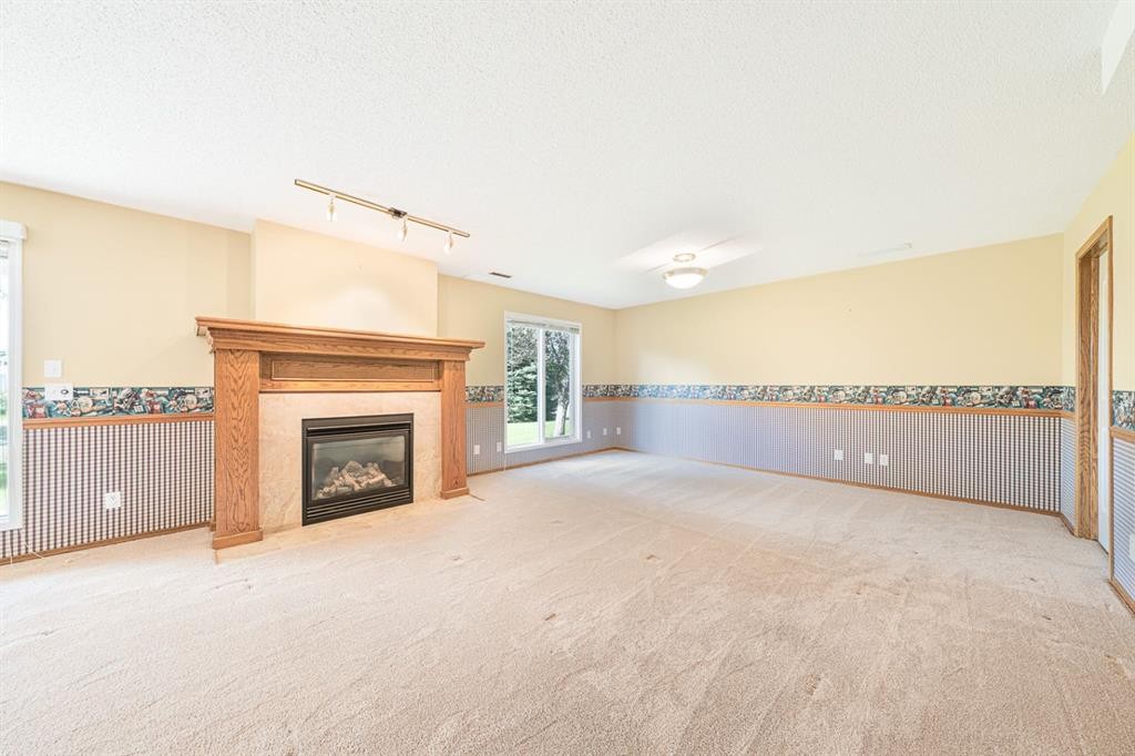 22 Douglas Woods Park Se, Calgary, AB - Indoor Photo Showing Other Room With Fireplace