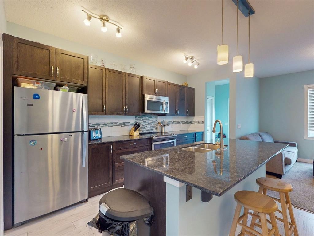 122 Midtown Boulevard Sw, Airdrie, AB - Indoor Photo Showing Kitchen With Double Sink