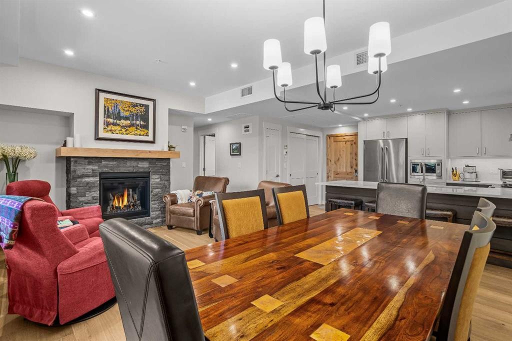 307-1505 Spring Creek Gate, Canmore, AB - Indoor Photo Showing Dining Room With Fireplace