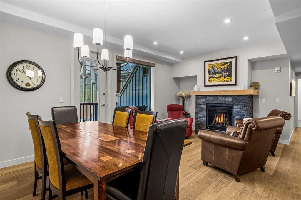 307-1505 Spring Creek Gate, Canmore, AB - Indoor Photo Showing Dining Room With Fireplace