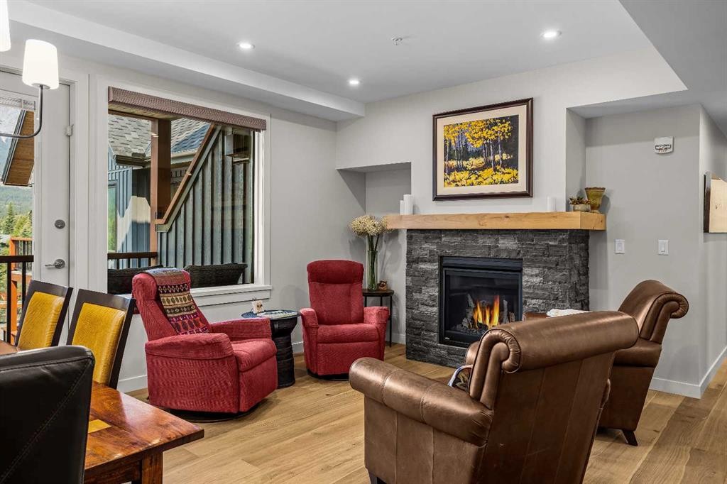 307-1505 Spring Creek Gate, Canmore, AB - Indoor Photo Showing Living Room With Fireplace