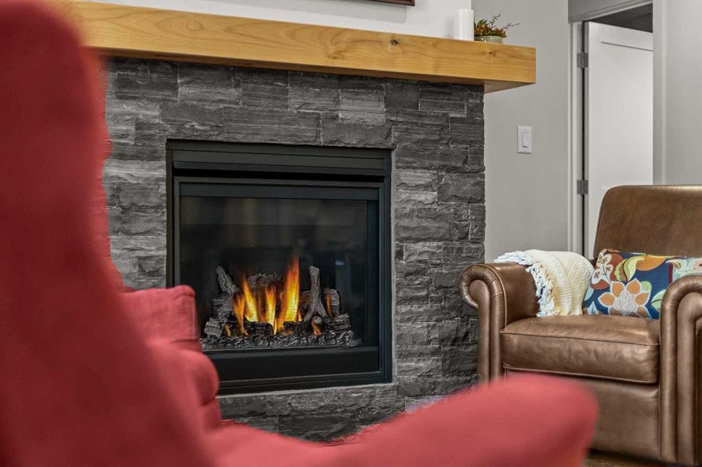 307-1505 Spring Creek Gate, Canmore, AB - Indoor Photo Showing Living Room With Fireplace