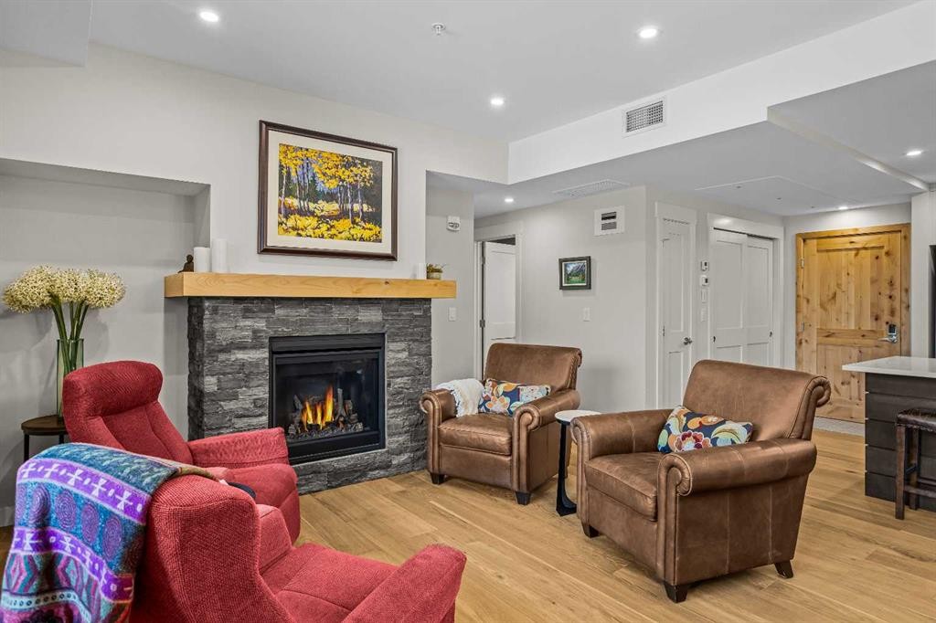 307-1505 Spring Creek Gate, Canmore, AB - Indoor Photo Showing Living Room With Fireplace