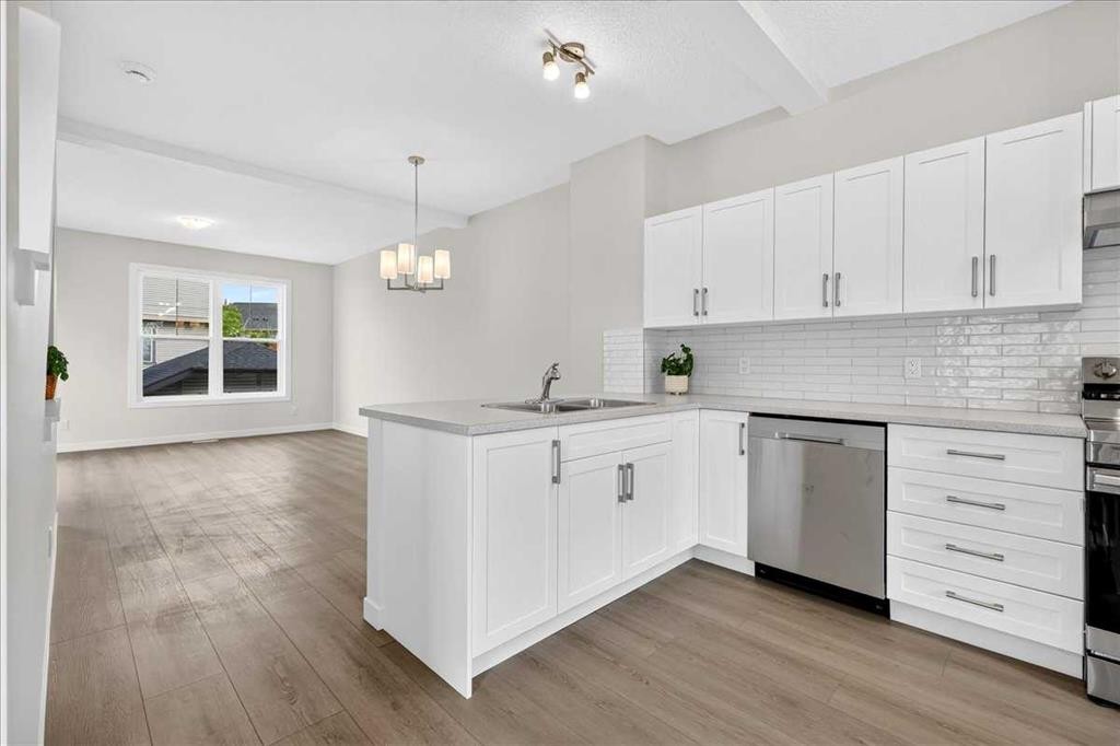 134 New Brighton Landing Se, Calgary, AB - Indoor Photo Showing Kitchen With Double Sink With Upgraded Kitchen