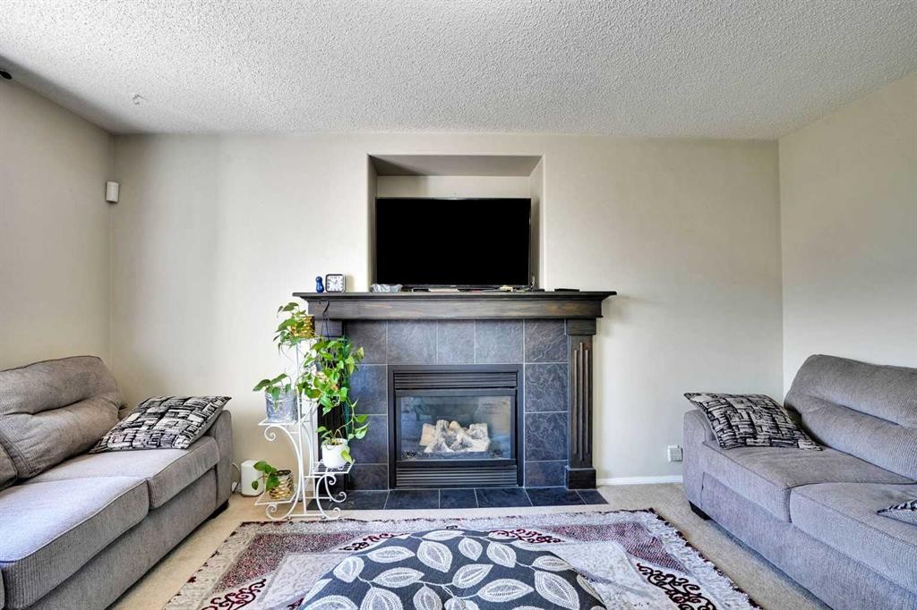 62 Covewood Manor, Calgary, AB - Indoor Photo Showing Living Room With Fireplace