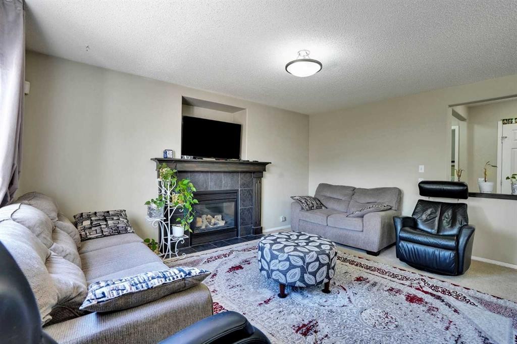 62 Covewood Manor, Calgary, AB - Indoor Photo Showing Living Room With Fireplace