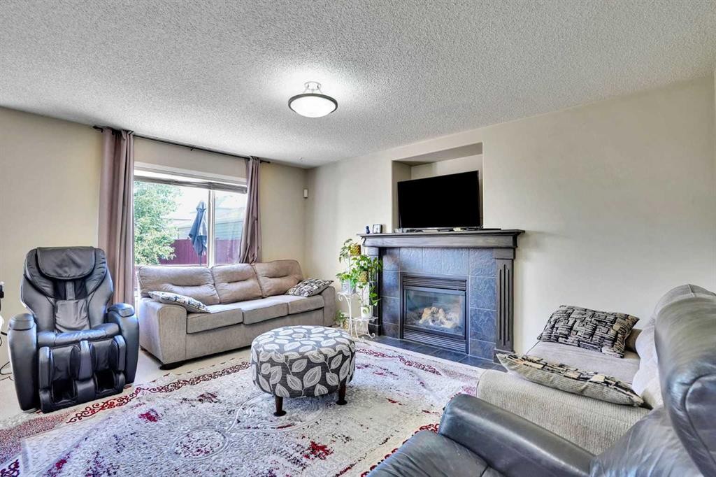 62 Covewood Manor, Calgary, AB - Indoor Photo Showing Living Room With Fireplace