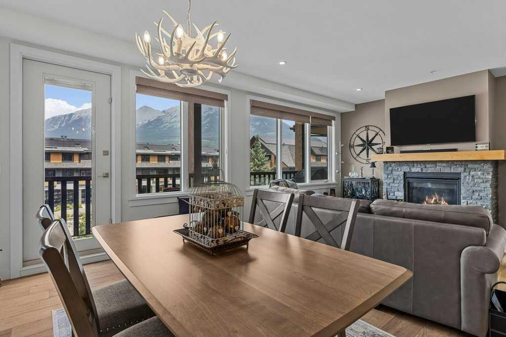311-1315 Spring Creek Gate, Canmore, AB - Indoor Photo Showing Dining Room With Fireplace