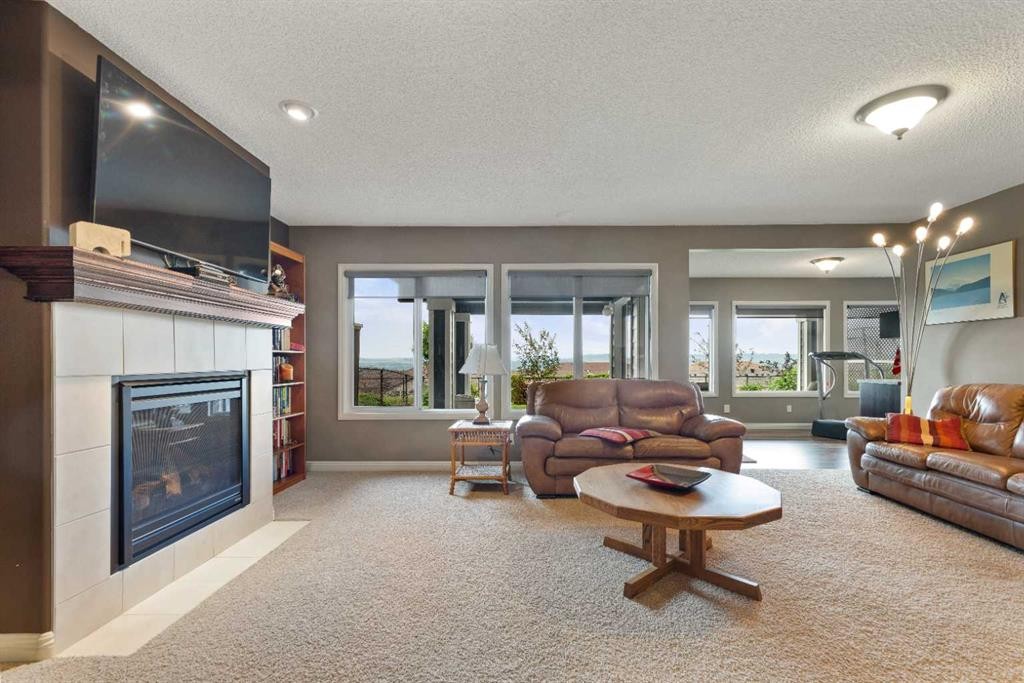 159 Sunset View, Cochrane, AB - Indoor Photo Showing Living Room With Fireplace