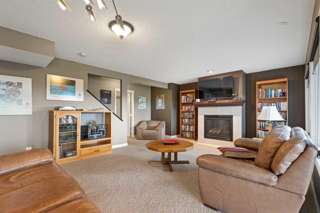 159 Sunset View, Cochrane, AB - Indoor Photo Showing Living Room With Fireplace