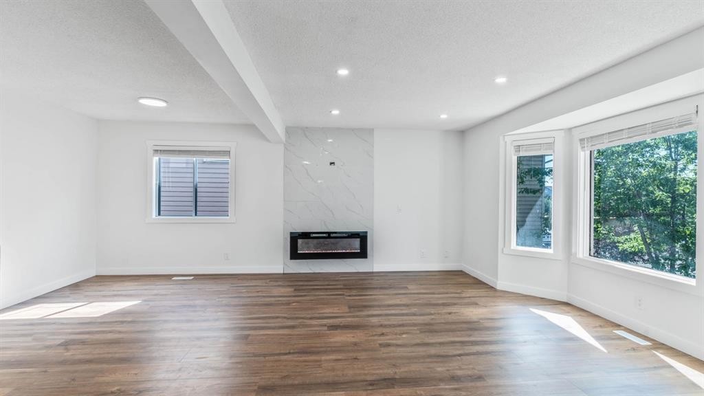 15 Taraglen Court Ne, Calgary, AB - Indoor With Fireplace