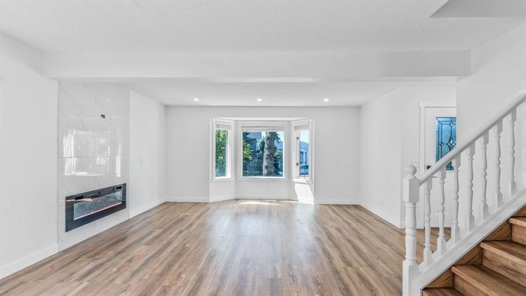 15 Taraglen Court Ne, Calgary, AB - Indoor With Fireplace
