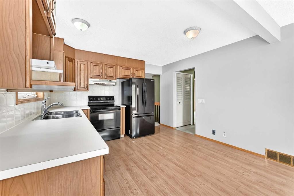 128 Erin Woods Drive Se, Calgary, AB - Indoor Photo Showing Kitchen With Double Sink
