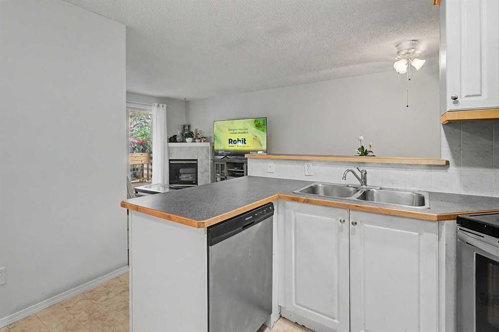 101-7724 Bowness Road Nw, Calgary, AB - Indoor Photo Showing Kitchen With Double Sink
