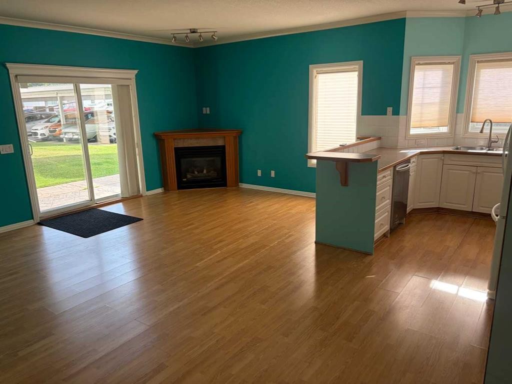 101-7 Lineham Avenue, Okotoks, AB - Indoor Photo Showing Living Room With Fireplace