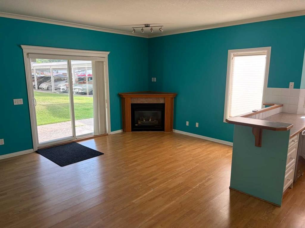 101-7 Lineham Avenue, Okotoks, AB - Indoor Photo Showing Living Room With Fireplace