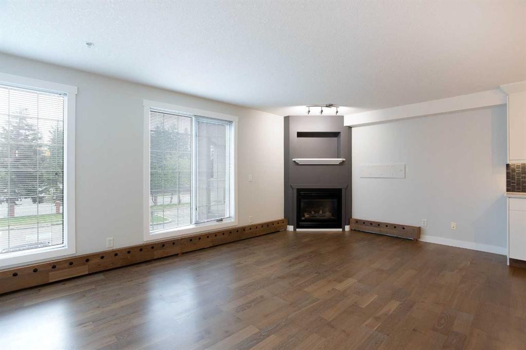 239-8535 Bonaventure Drive Se, Calgary, AB - Indoor Photo Showing Living Room With Fireplace