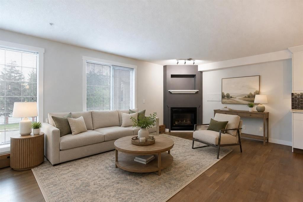 239-8535 Bonaventure Drive Se, Calgary, AB - Indoor Photo Showing Living Room With Fireplace