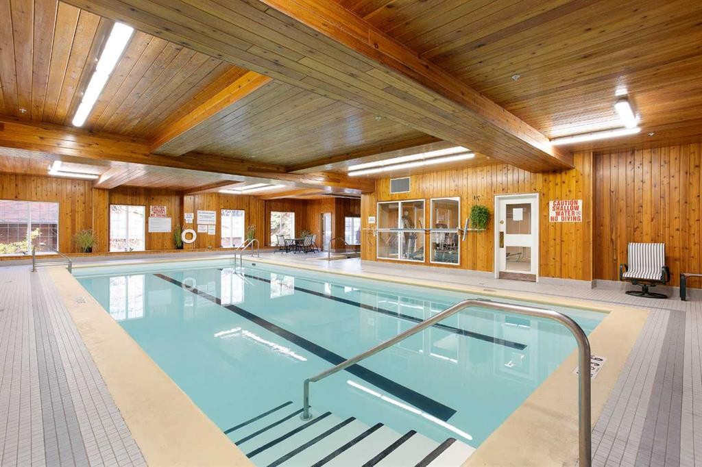 239-8535 Bonaventure Drive Se, Calgary, AB - Indoor Photo Showing Other Room With In Ground Pool