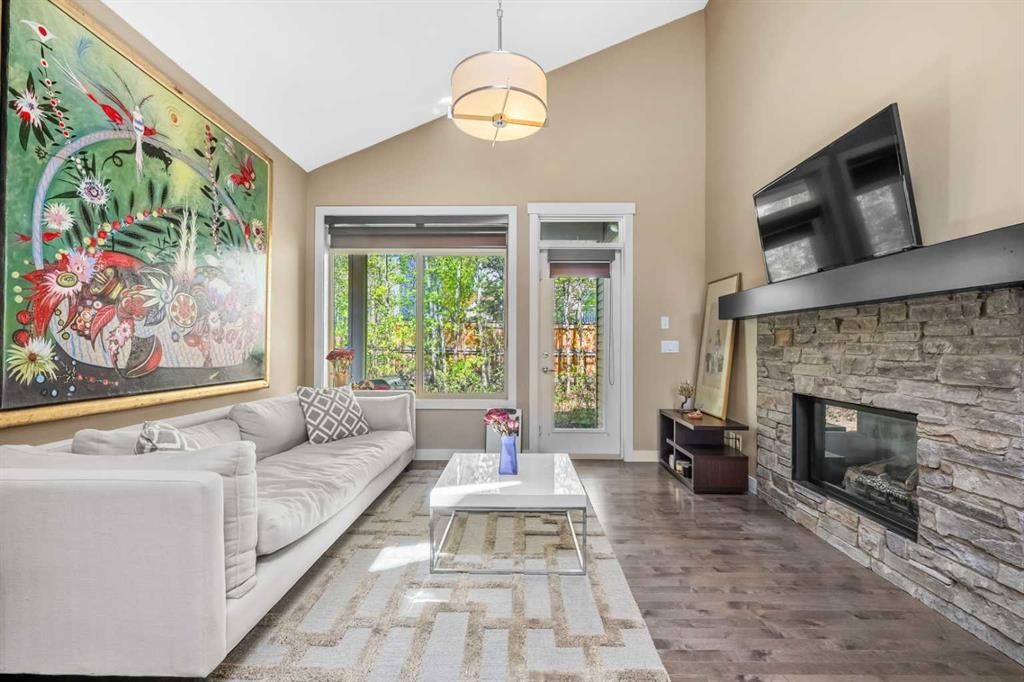 63 Cortina Villas Sw, Calgary, AB - Indoor Photo Showing Living Room With Fireplace