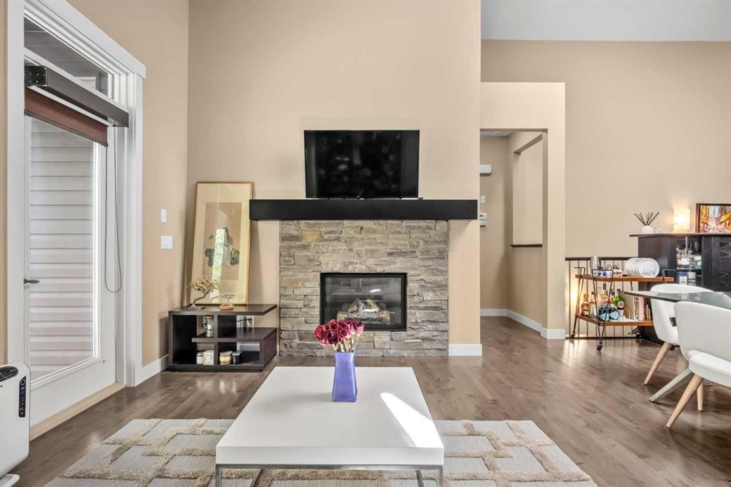 63 Cortina Villas Sw, Calgary, AB - Indoor Photo Showing Living Room With Fireplace