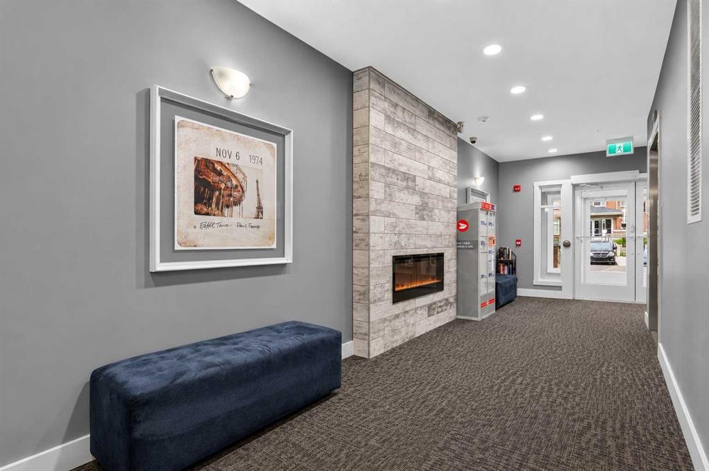 2115-3727 Sage Hill Drive Nw, Calgary, AB - Indoor Photo Showing Other Room With Fireplace