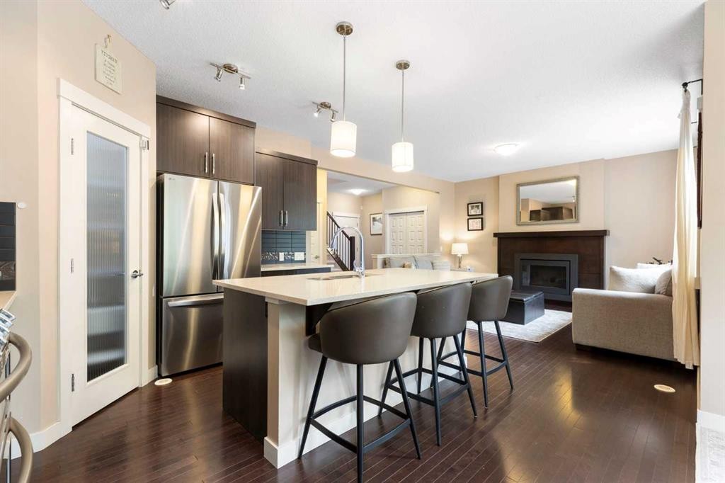 165 Cranarch Common Se, Calgary, AB - Indoor Photo Showing Kitchen With Fireplace With Upgraded Kitchen