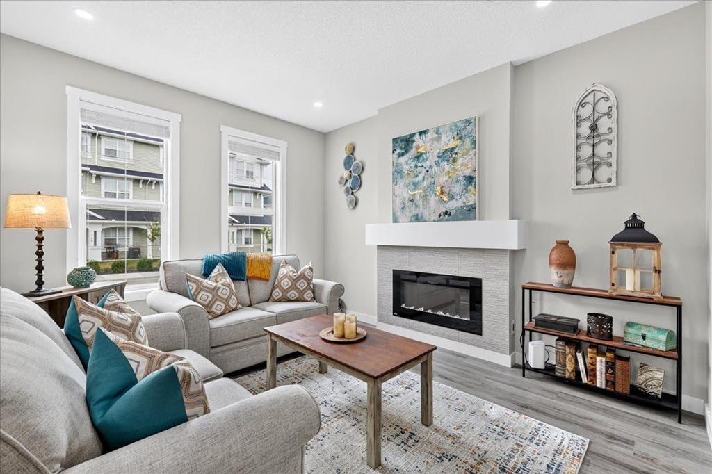 163 Copperleaf Way Se, Calgary, AB - Indoor Photo Showing Living Room With Fireplace