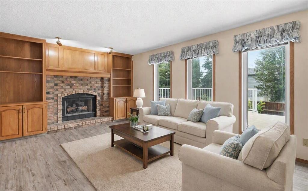 61 Shannon Crescent Sw, Calgary, AB - Indoor Photo Showing Living Room With Fireplace