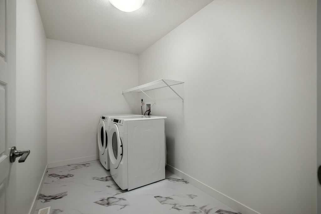 882 Bluerock Way Sw, Calgary, AB - Indoor Photo Showing Laundry Room