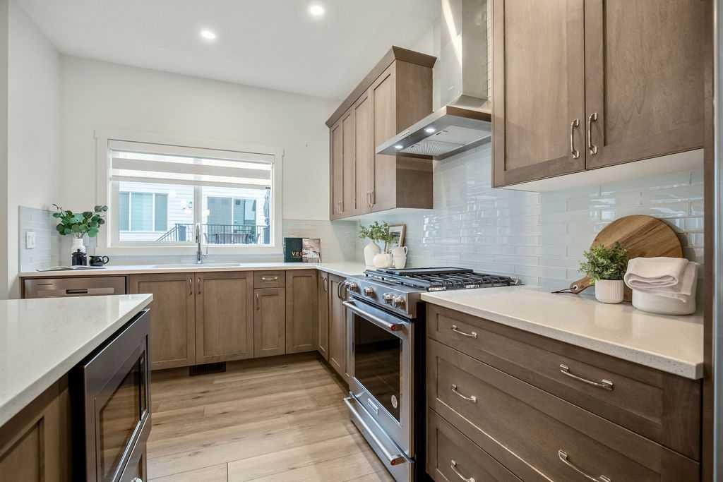 882 Bluerock Way Sw, Calgary, AB - Indoor Photo Showing Kitchen With Upgraded Kitchen