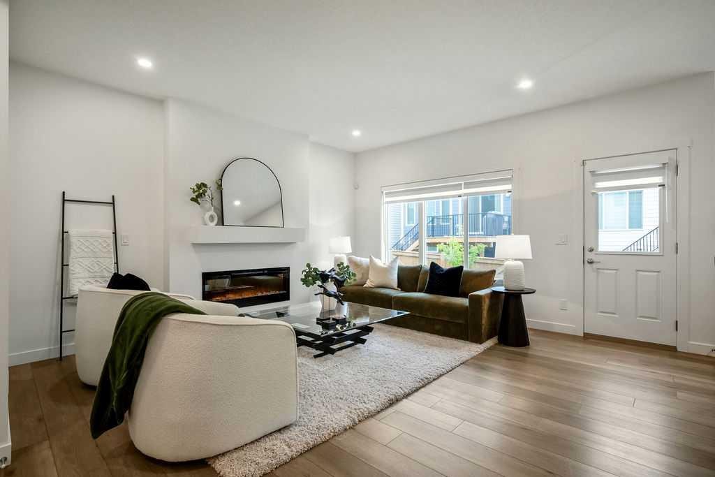 882 Bluerock Way Sw, Calgary, AB - Indoor Photo Showing Living Room With Fireplace