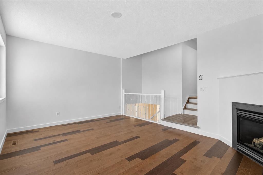 133 Martinvalley Crescent Ne, Calgary, AB - Indoor Photo Showing Other Room With Fireplace