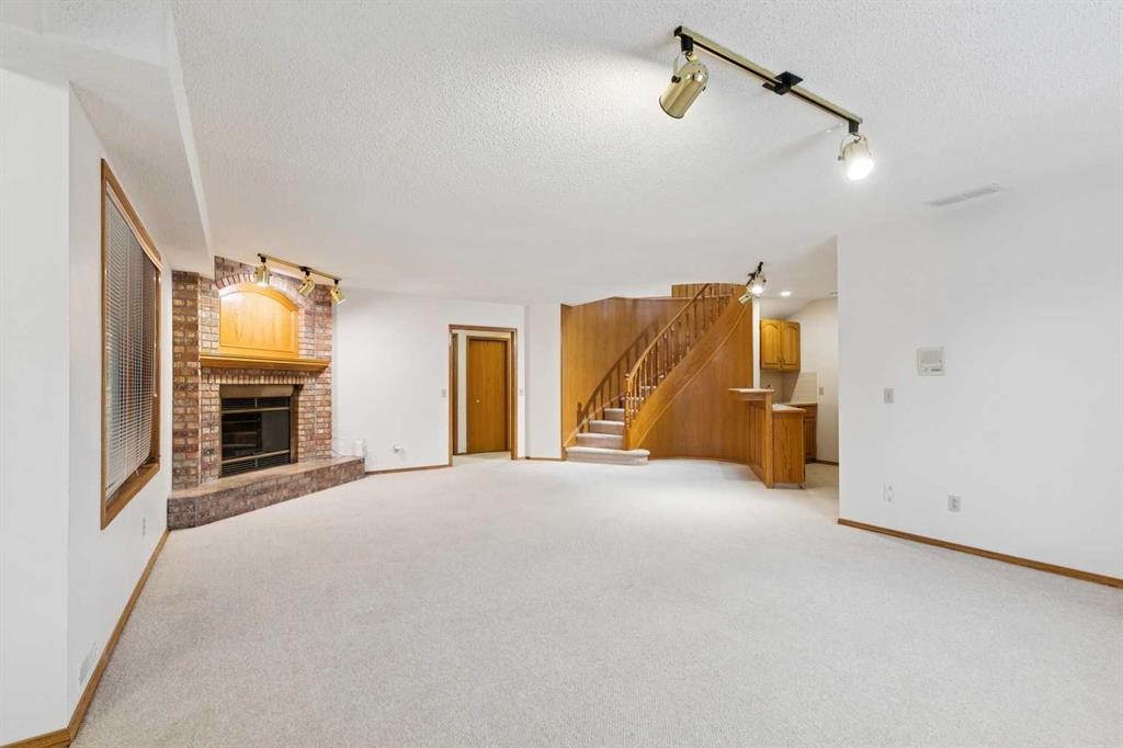 116 Scandia Rise Nw, Calgary, AB - Indoor Photo Showing Other Room With Fireplace
