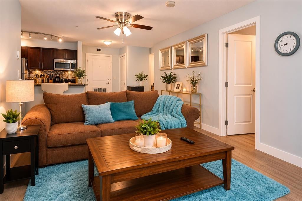 8112-403 Mackenzie Way Se, Airdrie, AB - Indoor Photo Showing Living Room