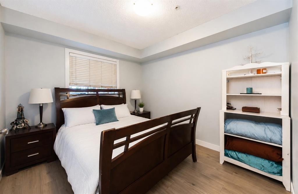 8112-403 Mackenzie Way Se, Airdrie, AB - Indoor Photo Showing Bedroom
