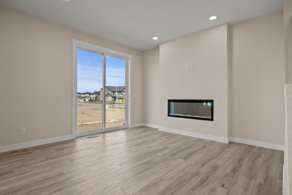 435 Kinniburgh Loop, Chestermere, AB - Indoor Photo Showing Living Room With Fireplace