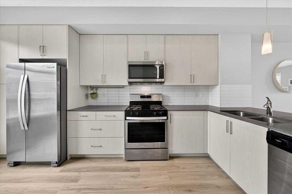 154 Seton Passage Se, Calgary, AB - Indoor Photo Showing Kitchen With Double Sink