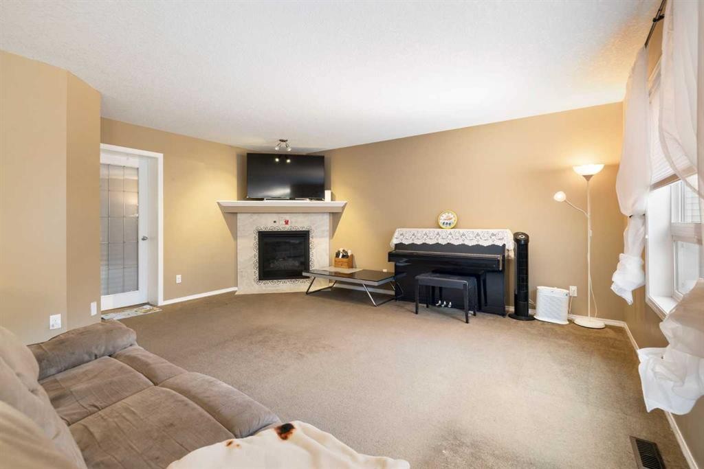 19 Silverado Skies Bay Sw, Calgary, AB - Indoor Photo Showing Living Room With Fireplace