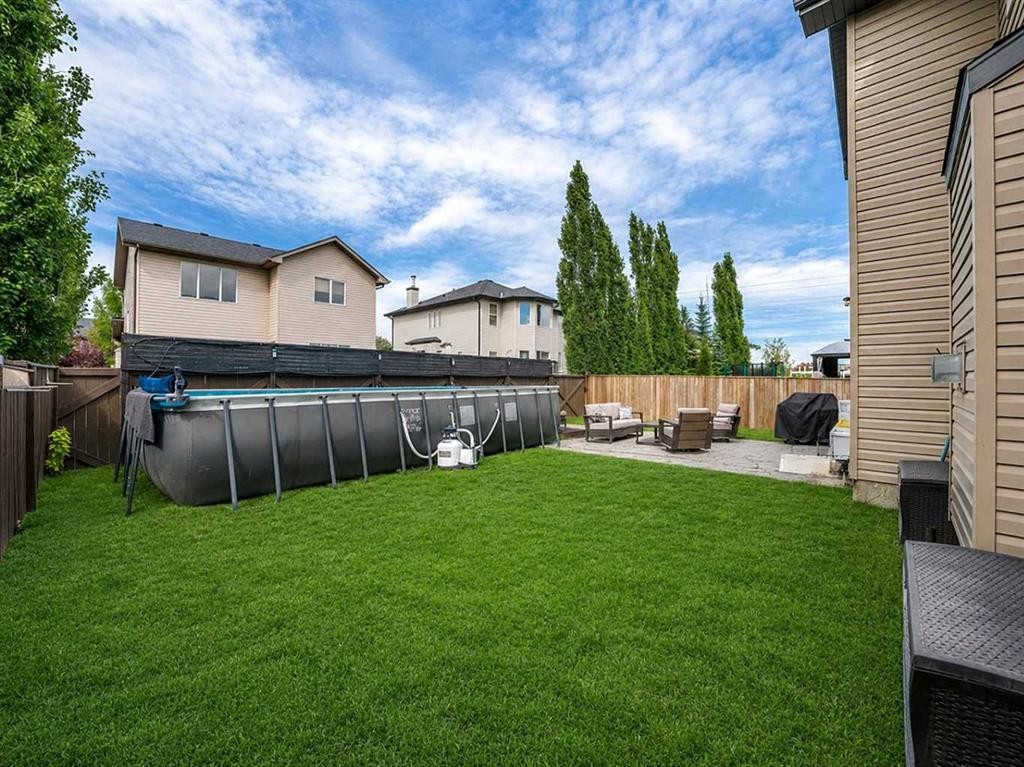 109 Seagreen Link, Chestermere, AB - Outdoor With Above Ground Pool With Backyard