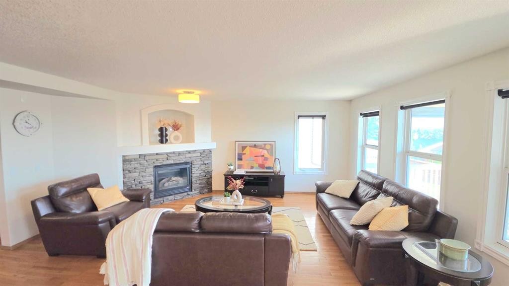210 Panamount Hill Nw, Calgary, AB - Indoor Photo Showing Living Room With Fireplace