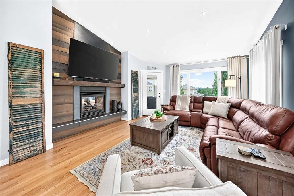 61 West Edge Road, Cochrane, AB - Indoor Photo Showing Living Room With Fireplace