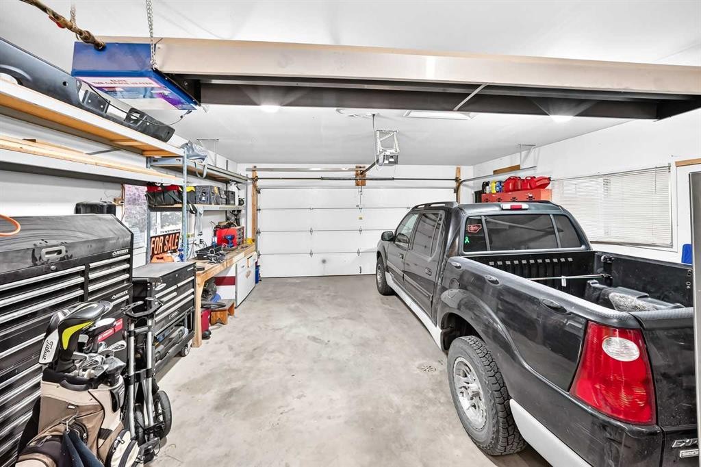 61 West Edge Road, Cochrane, AB - Indoor Photo Showing Garage