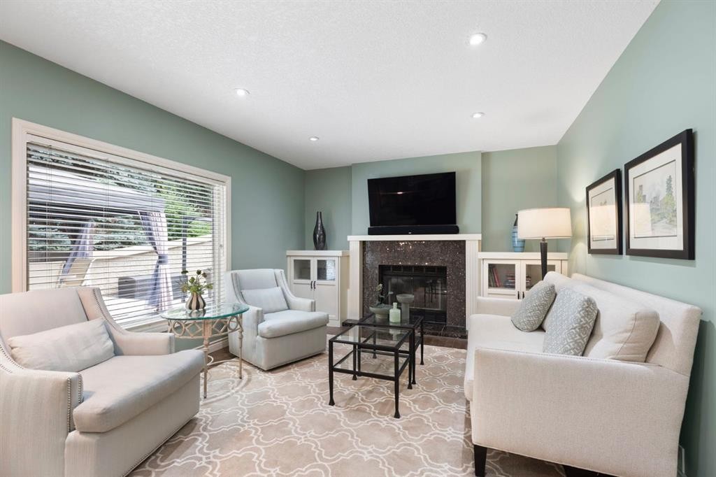 311 Woodhaven Bay Sw, Calgary, AB - Indoor Photo Showing Living Room With Fireplace
