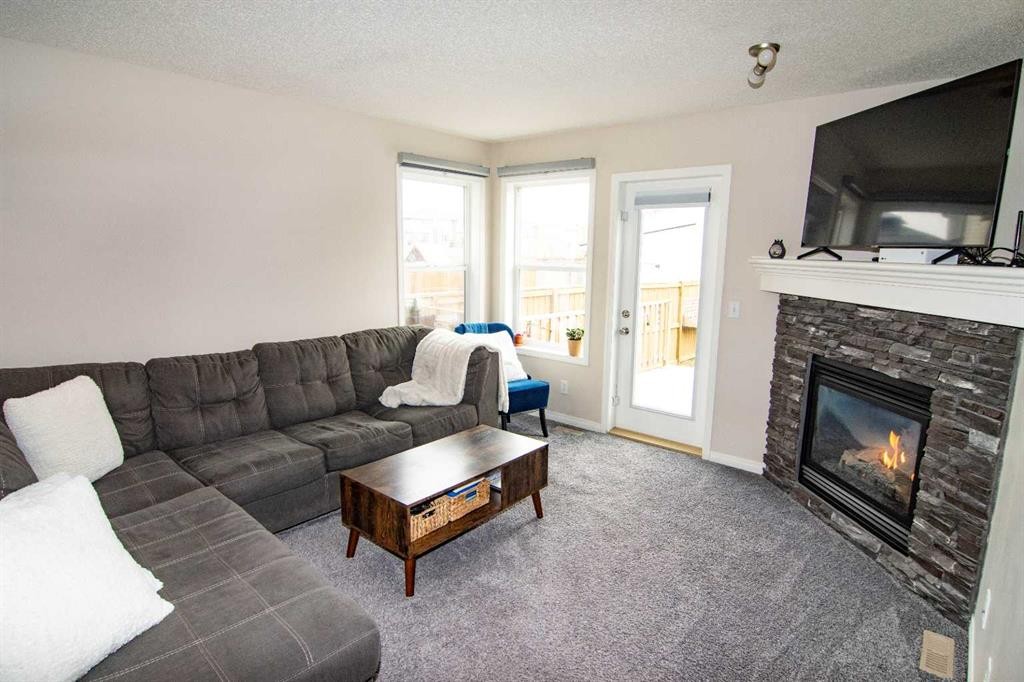 754 Luxstone Gate Sw, Airdrie, AB - Indoor Photo Showing Living Room With Fireplace