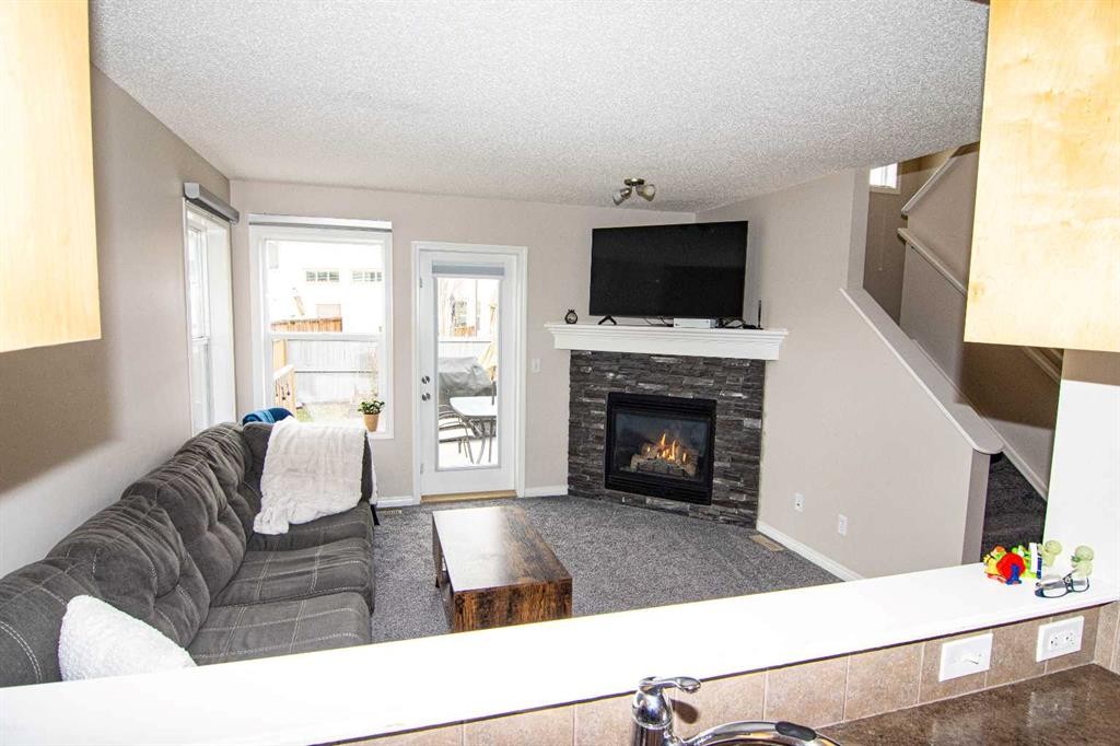 754 Luxstone Gate Sw, Airdrie, AB - Indoor Photo Showing Living Room With Fireplace