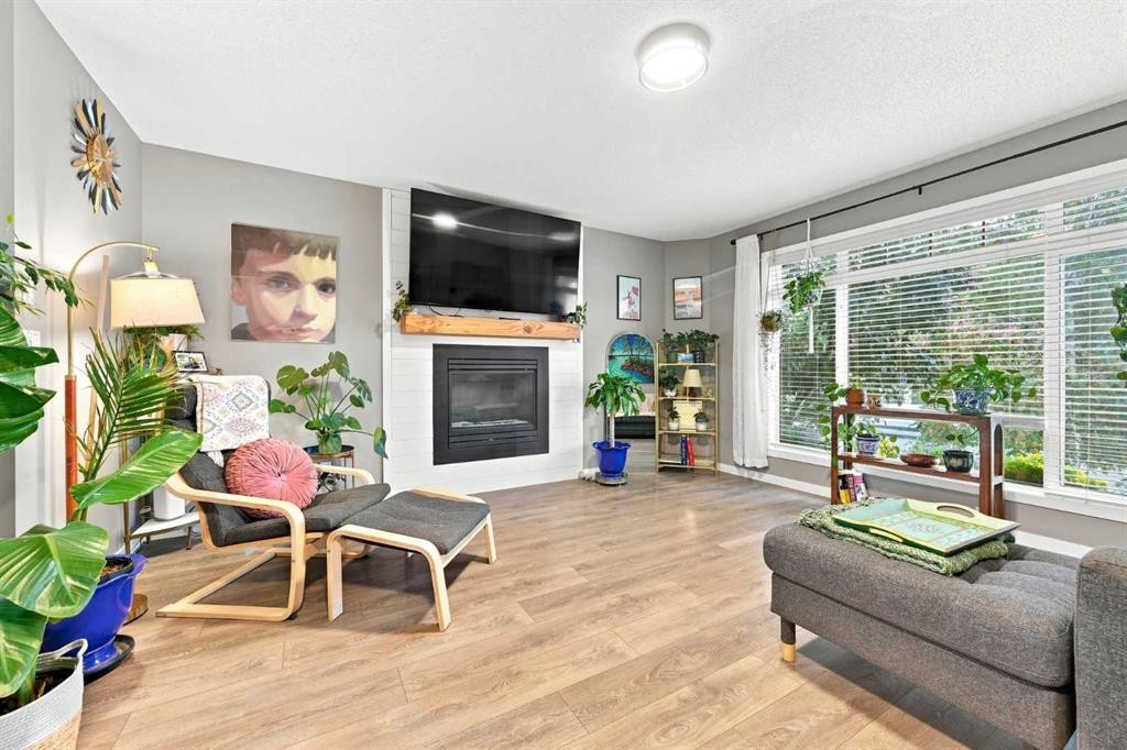 106 Autumn Crescent Se, Calgary, AB - Indoor Photo Showing Living Room With Fireplace