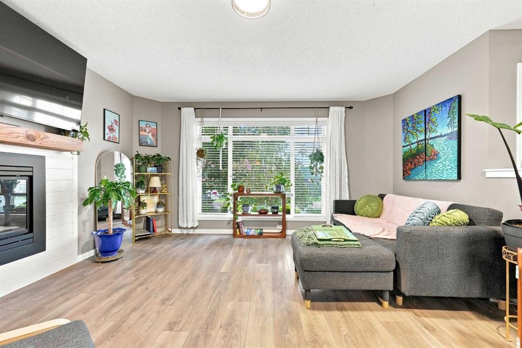 106 Autumn Crescent Se, Calgary, AB - Indoor Photo Showing Living Room With Fireplace
