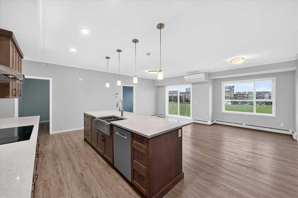 406-4350 Seton Drive Se, Calgary, AB - Indoor Photo Showing Kitchen With Double Sink With Upgraded Kitchen
