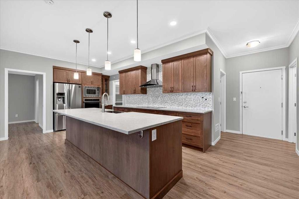 406-4350 Seton Drive Se, Calgary, AB - Indoor Photo Showing Kitchen With Stainless Steel Kitchen With Upgraded Kitchen
